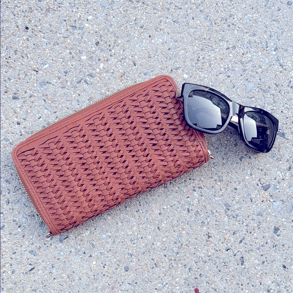 continental full zip wallet is crafted from medium brown leather, gold accents